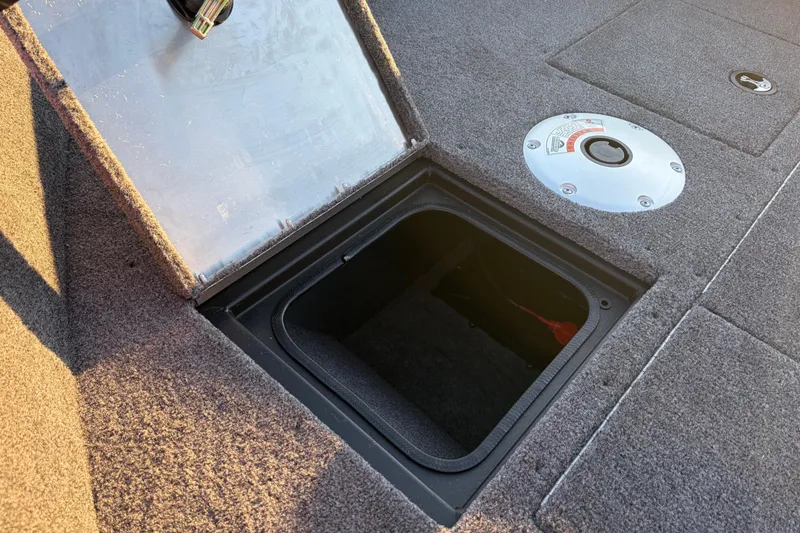 Slide: The Image of Open storage compartment on 2026 Tracker Pro Guide V-16 SC boat deck. - 82