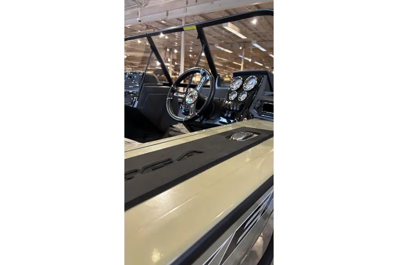 Slide: The Image of Interior view of 2026 Tracker Targa V-19 WT boat, showcasing steering wheel and dashboard controls. - 2