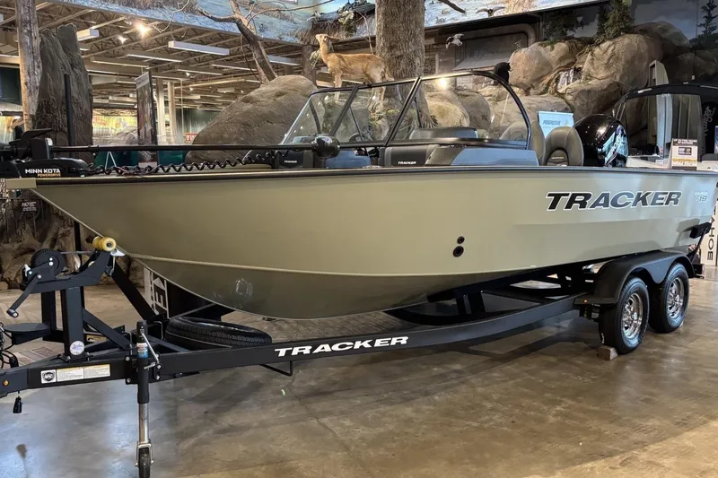 Slide: The Image of 2026 Tracker Targa V-19 WT boat displayed indoors on a trailer. - 4