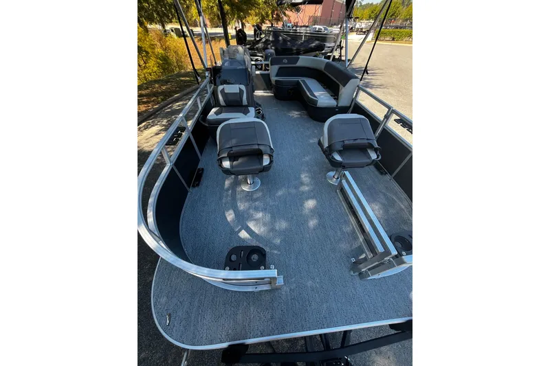 Slide: The Image of 2026 Sun Tracker Bass Buggy 16 XL Select pontoon boat interior with seating and helm. - 4