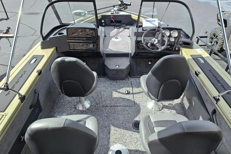 Slide: The Image of 2026 Tracker Targa V-18 Combo boat interior with four seats and modern dashboard. - 2
