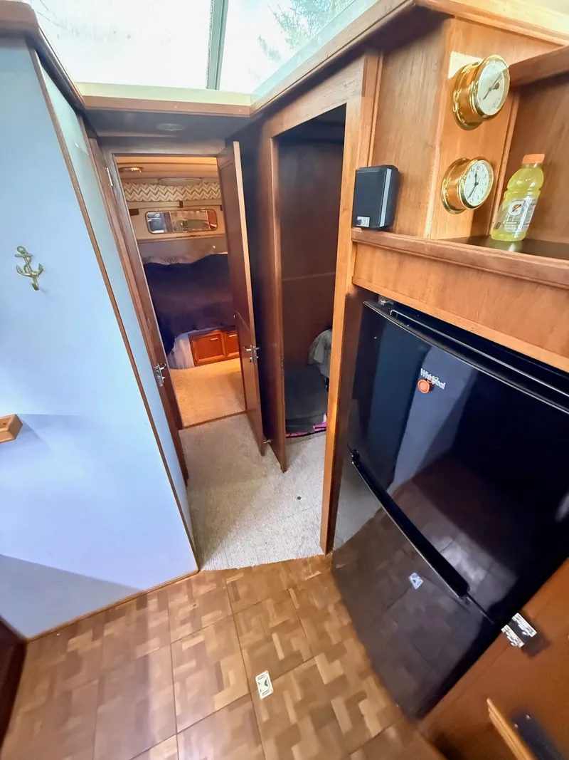 Slide: The Image of Interior of 1987 Carver 42 Cockpit Motor Yacht with wood paneling and appliances. - 12
