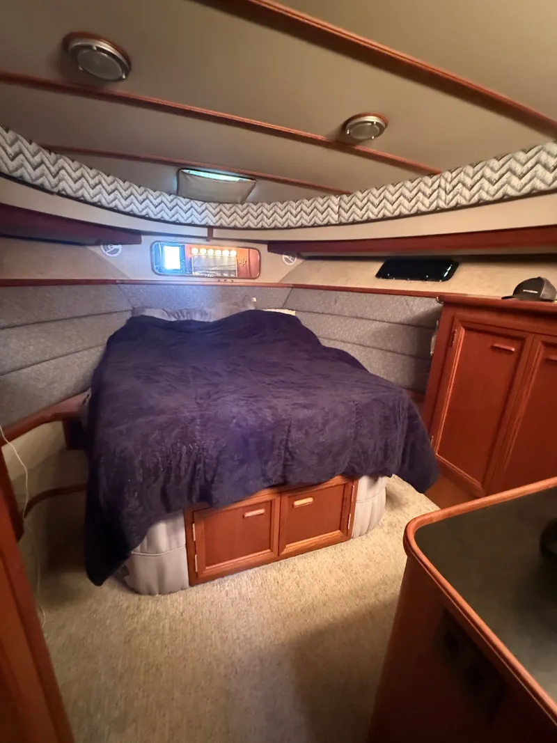 Slide: The Image of 1987 Carver 42 Cockpit Motor Yacht cabin with bed and wooden cabinetry. - 15