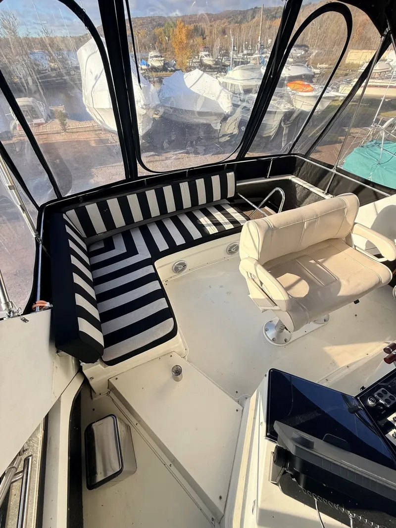 Slide: The Image of 1987 Carver 42 Cockpit Motor Yacht interior with striped seating and helm chair. - 21