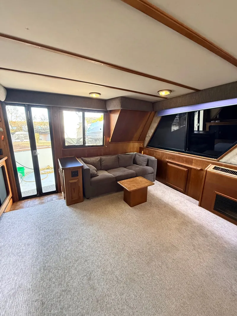 Slide: The Image of Interior of 1987 Carver 42 Cockpit Motor Yacht with sofa and wooden accents. - 9