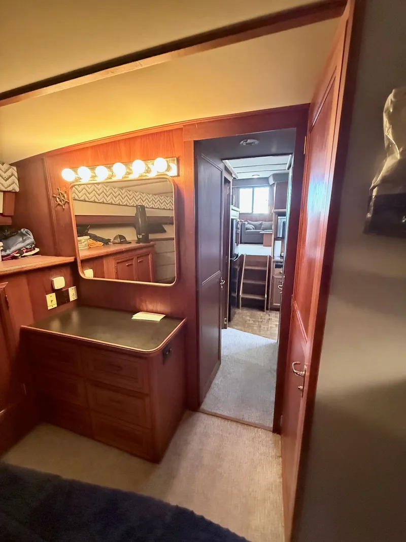 Slide: The Image of 1987 Carver 42 Cockpit Motor Yacht interior with vanity, mirror, and cozy cabin view. - 16