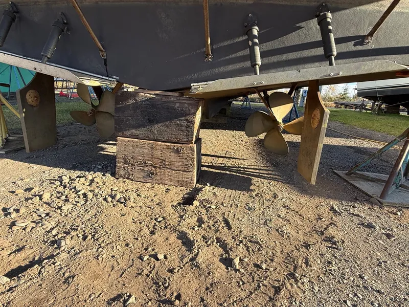 Slide: The Image of 1987 Carver 42 Cockpit Motor Yacht underside with propellers and rudders on dry dock. - 7