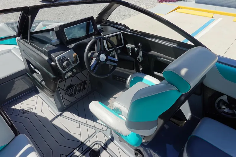 Slide: The Image of 2019 Malibu Wakesetter 23 LSV interior with modern dashboard and teal-accented seating. - 11