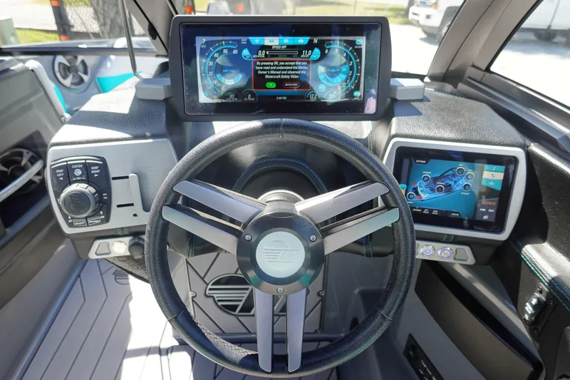 Slide: The Image of 2019 Malibu Wakesetter 23 LSV dashboard with advanced digital displays and controls. - 12