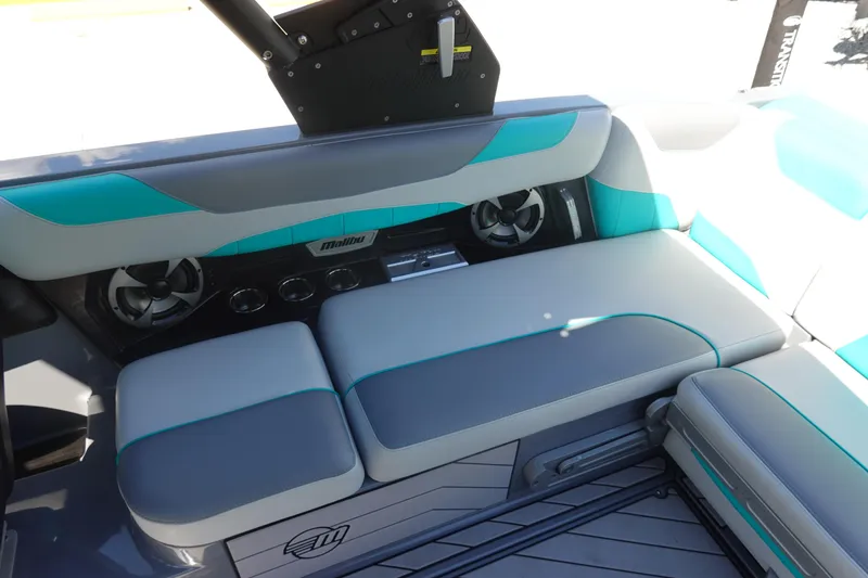 Slide: The Image of 2019 Malibu Wakesetter 23 LSV interior with gray and teal seating, featuring built-in speakers. - 18