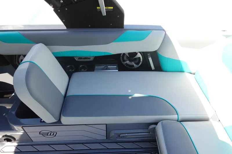 Slide: The Image of 2019 Malibu Wakesetter 23 LSV interior with gray and teal seating, featuring built-in speakers. - 20