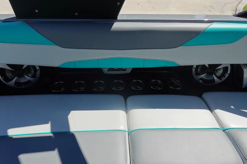 Slide: The Image of 2019 Malibu Wakesetter 23 LSV interior with teal and gray seating, cup holders, and speakers. - 23