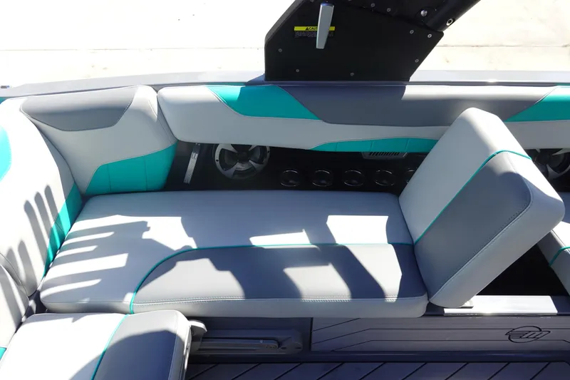 Slide: The Image of 2019 Malibu Wakesetter 23 LSV interior with gray and teal seating, featuring cup holders. - 24