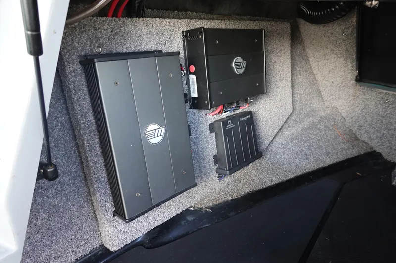 Slide: The Image of 2019 Malibu Wakesetter 23 LSV audio system components installed in carpeted compartment. - 27