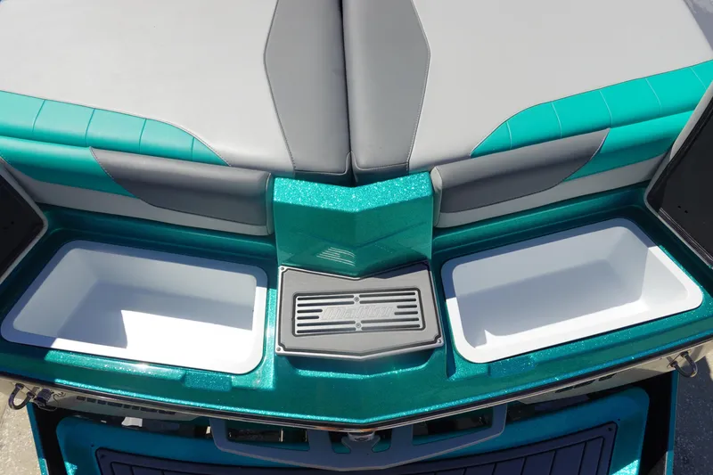 Slide: The Image of 2019 Malibu Wakesetter 23 LSV boat interior with teal and gray seating, storage compartments. - 9