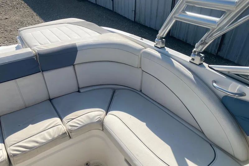 Slide: The Image of 2012 Bayliner 235 Bowrider interior seating with white and blue upholstery. - 11