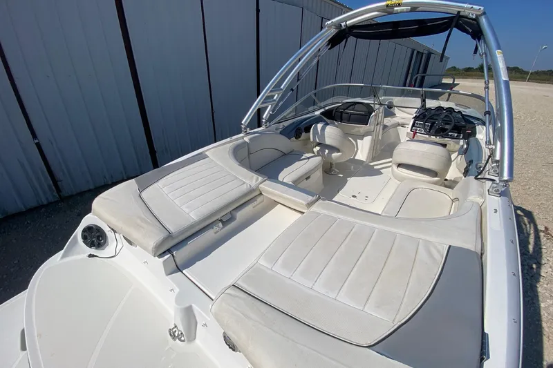 Slide: The Image of 2012 Bayliner 235 Bowrider boat interior with white seating and sleek design. - 5
