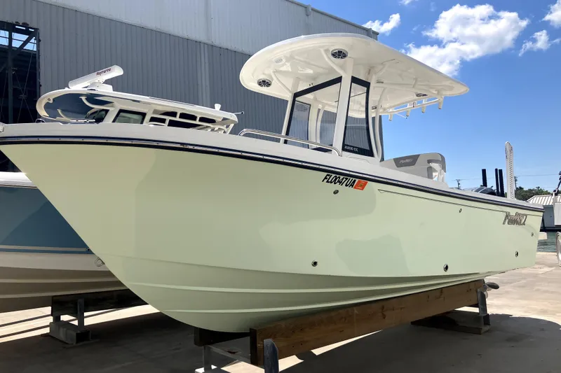 Slide: The Image of 2024 Parker 2200 Center Console boat on display under a clear blue sky. - 0