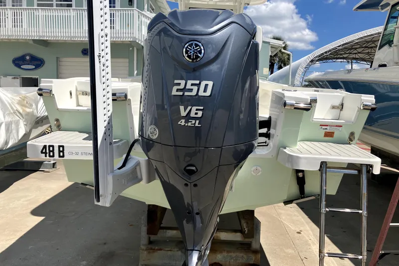 Slide: The Image of 2024 Parker 2200 Center Console boat with Yamaha 250 V6 engine, docked outdoors. - 1