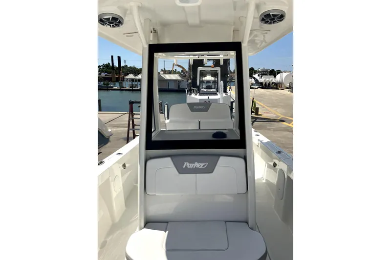 Slide: The Image of 2024 Parker 2200 Center Console boat interior at dock, showcasing seating and console design. - 18
