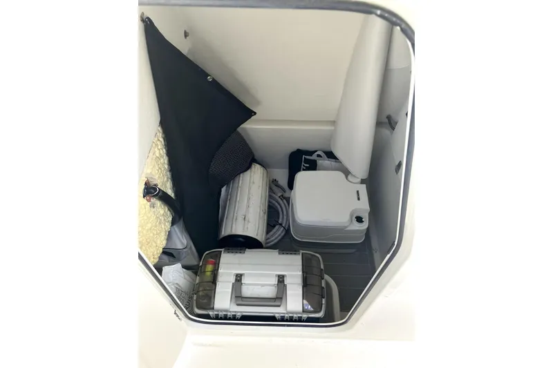 Slide: The Image of Storage compartment of 2024 Parker 2200 Center Console boat with various equipment. - 19
