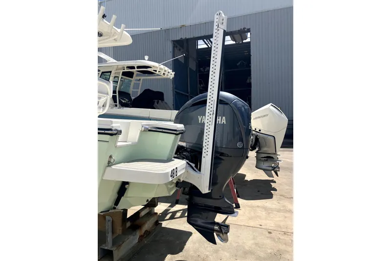 Slide: The Image of 2024 Parker 2200 Center Console boat with Yamaha outboard motor in a marina. - 21