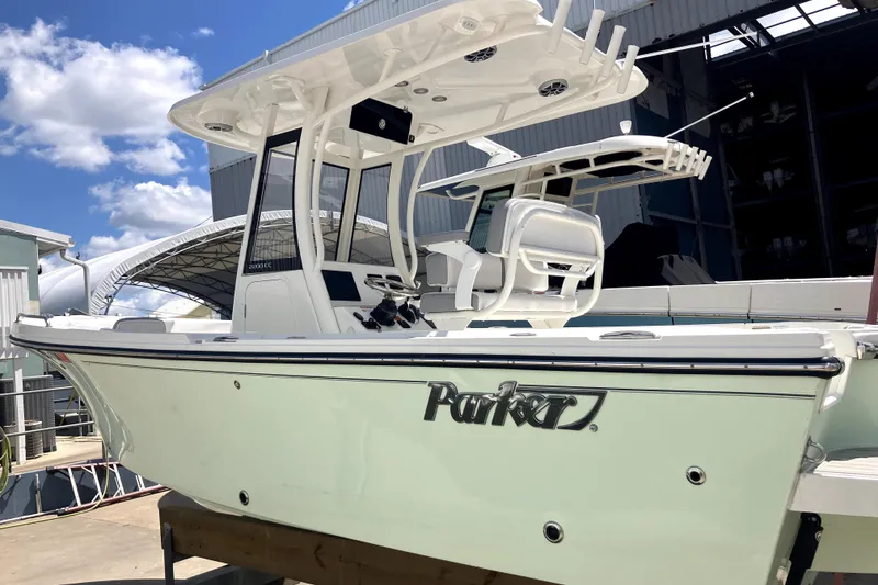 Slide: The Image of 2024 Parker 2200 Center Console boat docked under a clear blue sky. - 22