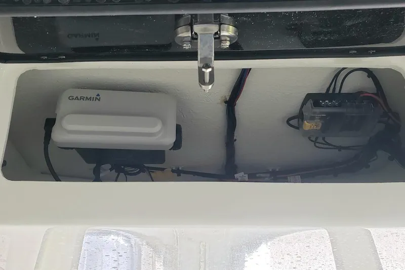 Slide: The Image of 2024 Parker 2200 Center Console electronics compartment with Garmin device and wiring. - 6