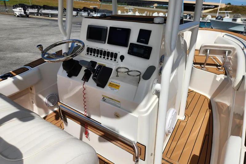 Slide: The Image of 2013 Sea Fox 226 Commander boat dashboard with steering wheel and navigation controls. - 10