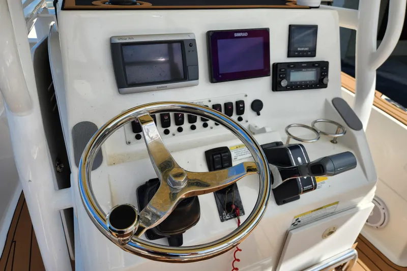 Slide: The Image of Control panel of 2013 Sea Fox 226 Commander boat with steering wheel and navigation equipment. - 11