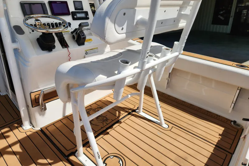 Slide: The Image of 2013 Sea Fox 226 Commander boat interior with helm, controls, and rod holders. - 14
