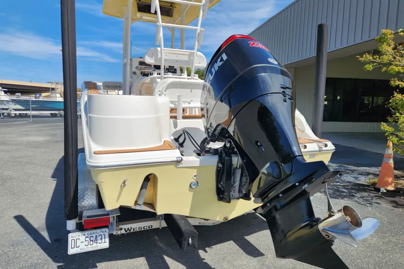 Slide: The Image of 2013 Sea Fox 226 Commander boat with Suzuki outboard motor, parked on a trailer. - 3