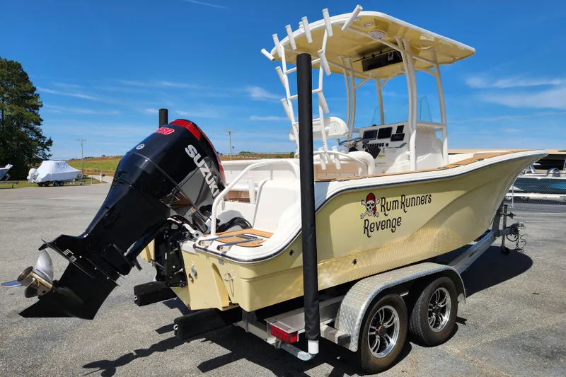 Slide: The Image of 2013 Sea Fox 226 Commander boat with Suzuki engine on trailer, labeled "Rum Runners Revenge." - 5