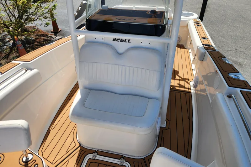 Slide: The Image of 2013 Sea Fox 226 Commander boat interior with white seating and wood-style flooring. - 9