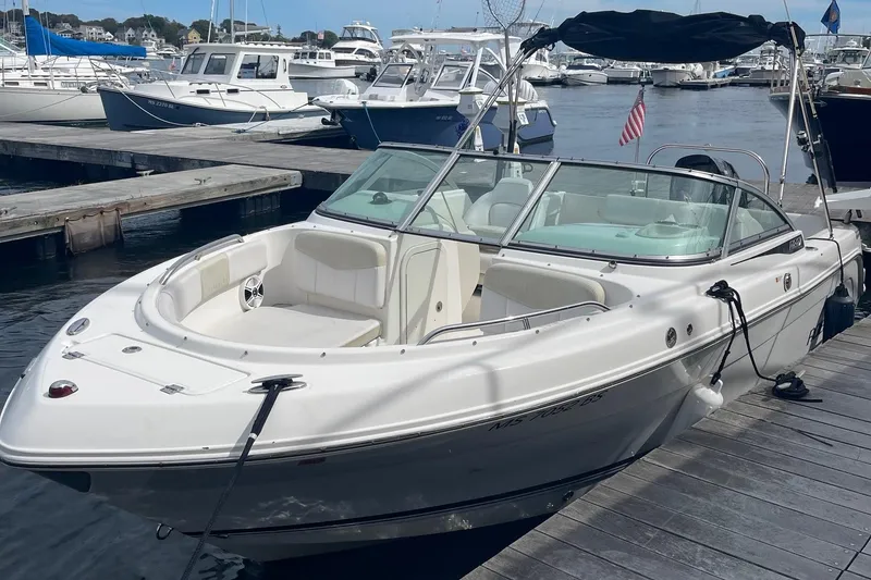 Slide: The Image of 2016 Robalo R247 Dual Console boat docked at marina, featuring sleek design and spacious seating. - 2