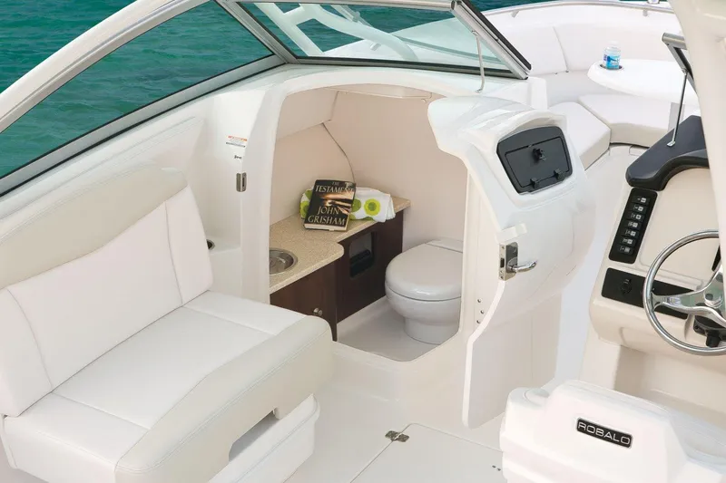 Slide: The Image of Manufacturer Provided Image: 2016 Robalo R247 Dual Console boat interior with toilet and seating. - 4