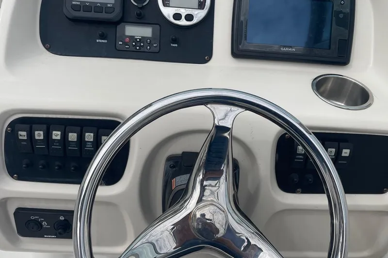 Slide: The Image of 2016 Robalo R227 Dual Console dashboard with steering wheel and navigation controls. - 7
