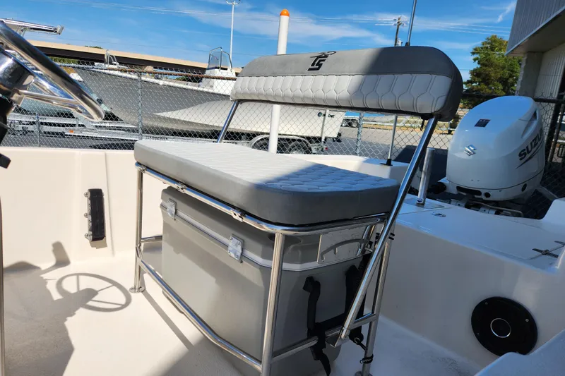 Slide: The Image of 2025 Carolina Skiff 178 JLS boat interior with seating and Suzuki outboard motor. - 10