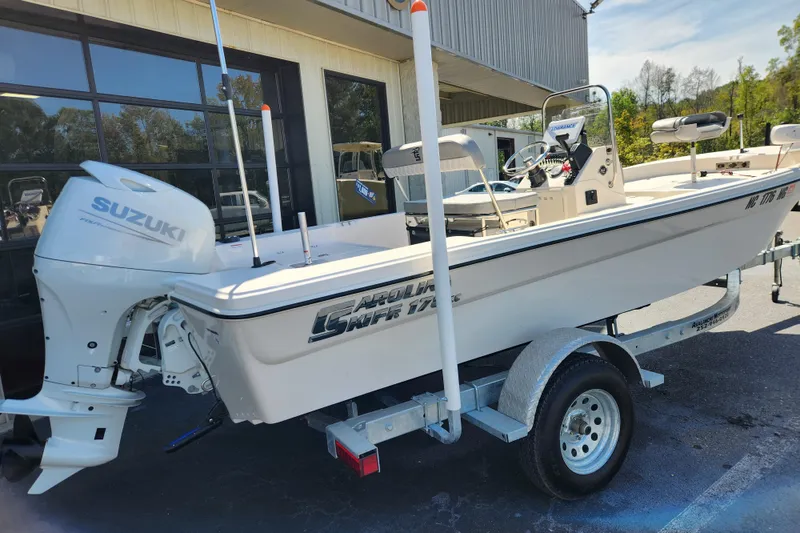 Slide: The Image of 2025 Carolina Skiff 178 JLS boat with Suzuki outboard motor on a trailer. - 2