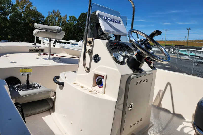 Slide: The Image of 2025 Carolina Skiff 178 JLS boat interior with steering console and seating. - 9