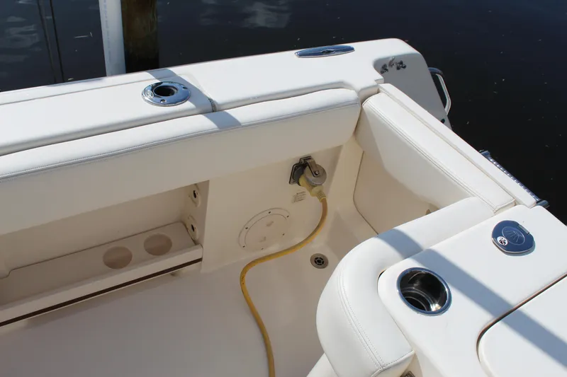 Slide: The Image of 2018 Grady-White Canyon 306 boat interior with white seating and cup holders. - 22