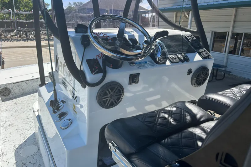 Slide: The Image of 2020 Dargel Kat 250 HDX boat interior with steering wheel and black leather seats. - 20