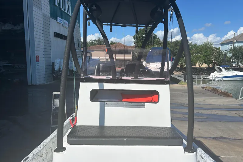 Slide: The Image of 2020 Dargel Kat 250 HDX boat at dock, featuring a sturdy console and seating. - 27