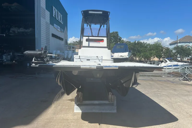 Slide: The Image of 2020 Dargel Kat 250 HDX boat on a dock, with a clear blue sky background. - 3
