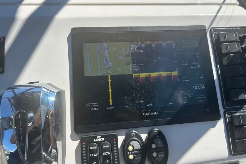 Slide: The Image of Garmin marine display on 2020 Dargel Kat 250 HDX boat dashboard with controls. - 38