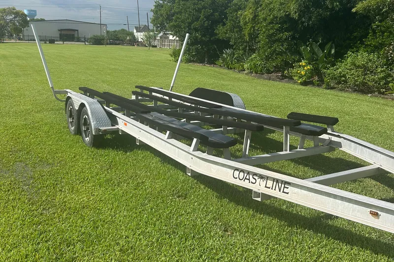 Slide: The Image of 2020 Dargel Kat 250 HDX boat trailer on green grass, featuring dual axles. - 52