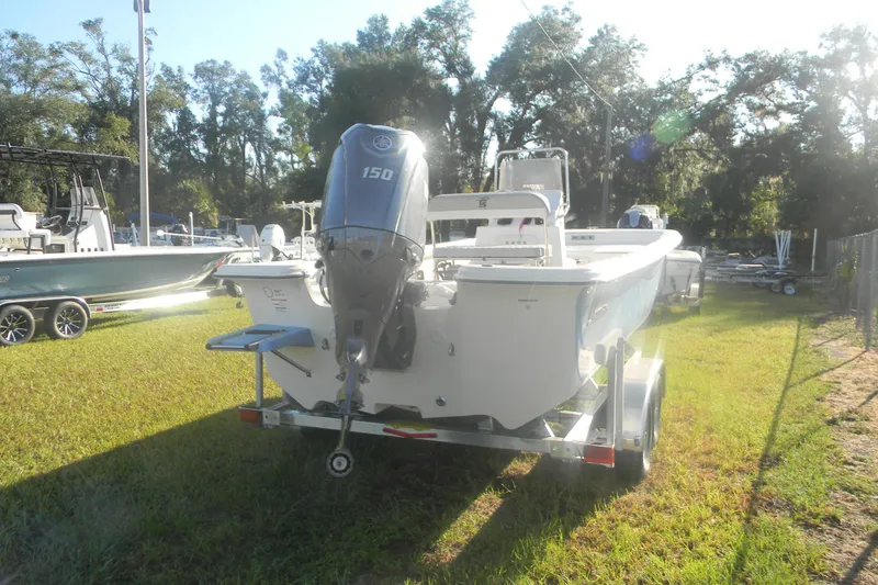 Slide: The Image of 2026 Carolina Skiff 21 LS boat on trailer, parked on grass, rear view. - 2