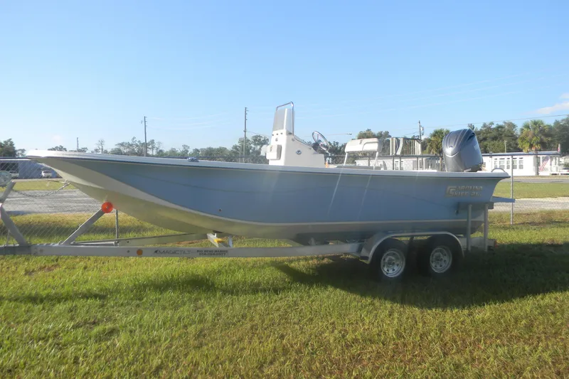 Slide: The Image of 2026 Carolina Skiff 21 LS boat on trailer, parked on grass. - 3