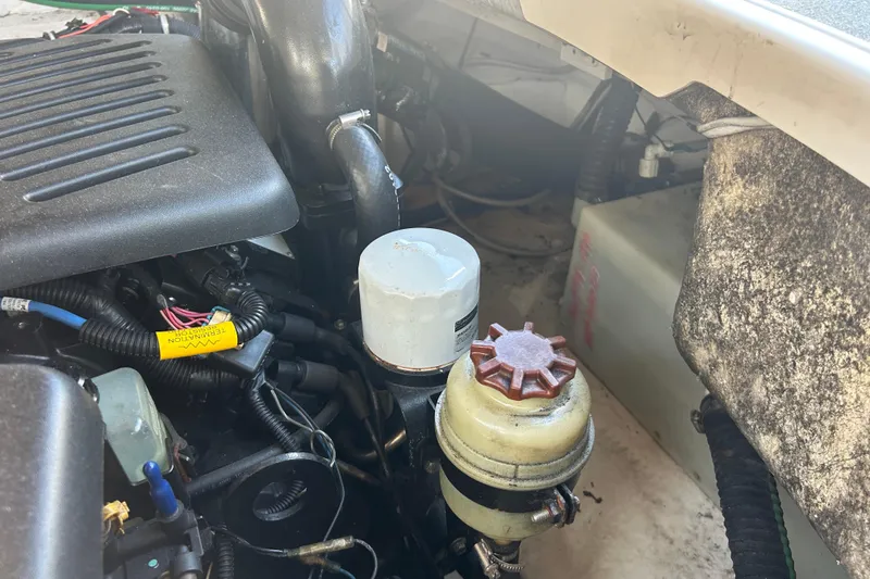 Slide: The Image of Engine compartment of a 2008 Chaparral 275 SSi boat, showing various components and wiring. - 13