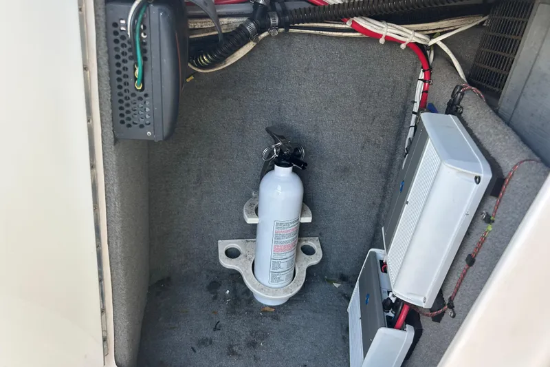 Slide: The Image of 2008 Chaparral 275 SSi boat interior with fire extinguisher and electrical components. - 17
